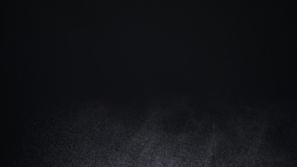 White exploding powder over black background