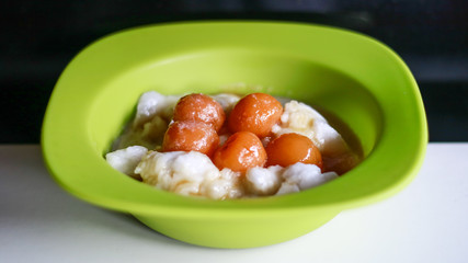 Bubur sum sum on black background. Bubur sum sum is an Indonesian dessert made by cooking rice flour in coconut milk and served with palm sugar syrup.