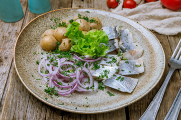 Herring with potatoes on plate