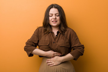 Young curvy russian woman sick, suffering from stomachache, painful disease concept.