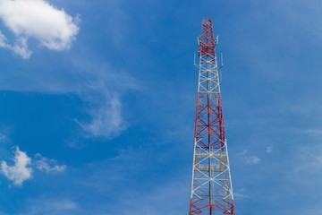 Mobile phone tower with blue sky and cloud.