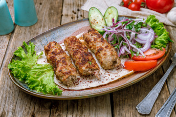 Lamb Lula kebab on wooden background