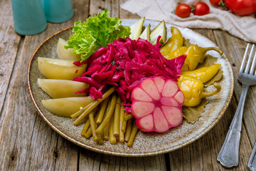 plate of pickles on wooden background