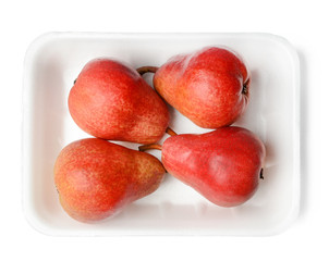 Red pear in plastic packaging. White isolated background. Close-up. Top view.