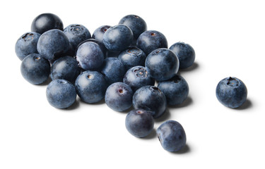 A small pile of fresh juicy blueberries isolated on white. Side view.