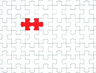 White puzzle pieces on a red background separated