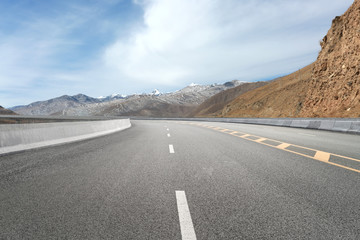 Empty highways and distant mountains