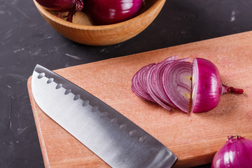 red onion cut on a wooden board