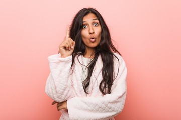 Young indian woman wearing pajama having some great idea, concept of creativity.
