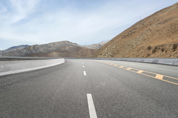 Empty highways and distant mountains