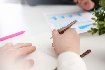 Group of people hold silver pen ready to make note in clipboard pad sheet closeup. Training course university practice homework school or college exercise secretary table management concept