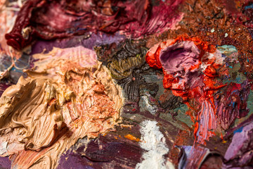 Background image of bright oil-paint palette closeup.