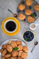 Italian healthy breakfast: homemade cookies - biscotti - made from ricotta, fresh blueberries, barley coffee, coconut milk