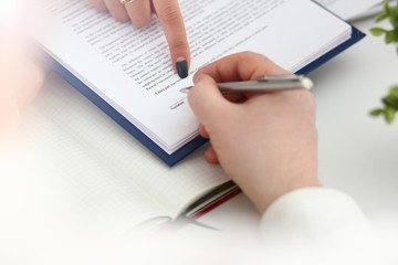 Arm fill and sign important form clipped to pad with silver pen closeup. Make note gesture read pact sale agent bank job loan credit mortgage investment finance chief legal law take part in campaign