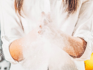 Culinary master class. Lady slapping hands, shaking off flour. Pastry baking course.