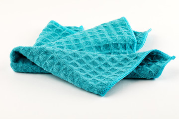 Clean blue kitchen towel on white background.