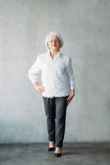 Senior lady full length. Hand on hip pose. Confident business female. Classy smart successful...
