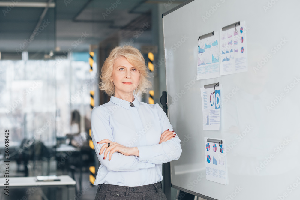 Wall mural confident business woman waist up. arms folded. successful top coach. mentoring training inspiration