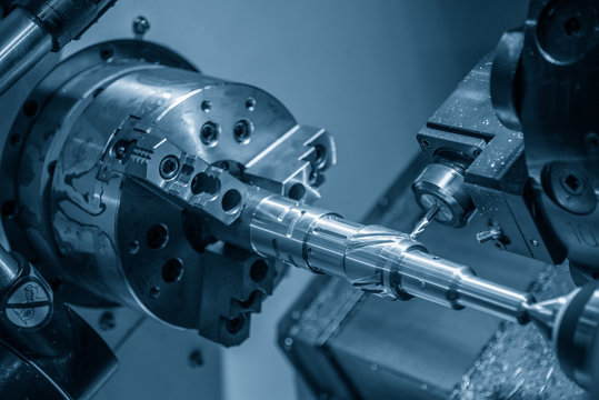 The CNC lathe machine slot cutting by the milling turret. Hi-technology automotive part manufacturing process on turning machine.