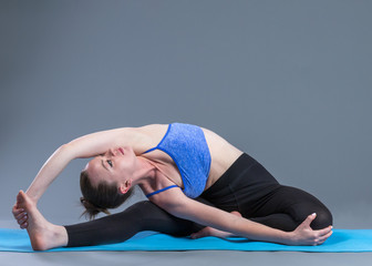 Fototapeta na wymiar Beautiful sporty fit young woman practices yoga asana.