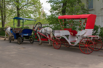 Walking carriages drawn by horses in the old streets of Suzdal. Russia.