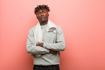 Fototapeta premium Young fitness african black man unhappy looking in camera with sarcastic expression.