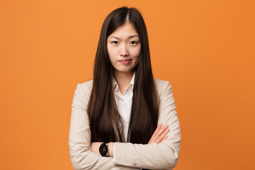 Young business chinese woman unhappy looking in camera with sarcastic expression.