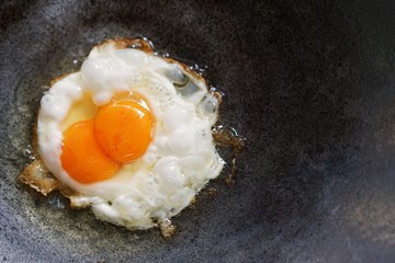 Double yolk eggs in frying pan. Thai style fried egg.