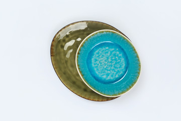 Simple rustic handmade blue crockery  on a white background