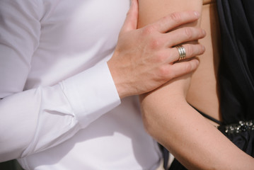 Obraz na płótnie Canvas Man hugging a woman in a dress close-up