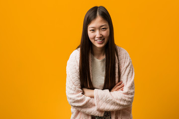 Fototapeta premium Young chinese woman in pajama laughing and having fun.