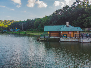 Fototapeta na wymiar view of beautiful lake house. resort park near forest