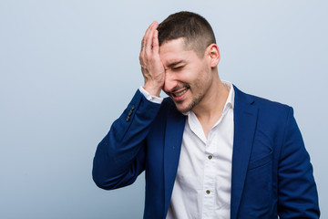 Young business caucasian man forgetting something, slapping forehead with palm and closing eyes.