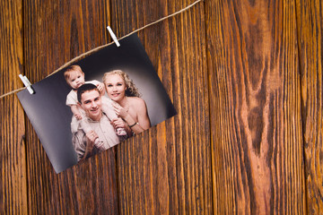 Family day concept. Photo of a young family on a wooden background with space for text