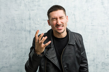 Young rocker man screaming with rage.