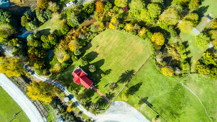 Little church on a small field surrounded by trees and garden. Auckland, New Zealand