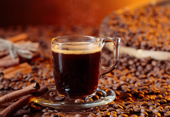 Espresso coffee cup with cinnamon sticks.