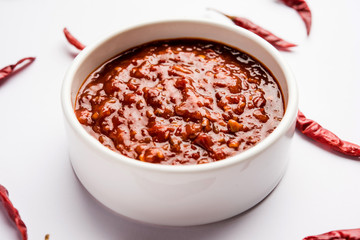 Schezwan Sauce / Szechuan chutney is an important ingredient in Chinese recipe. served in a bowl, isolated.  selective focus