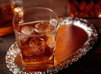 Glass of scotch whiskey and natural ice .