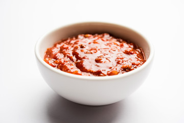 Schezwan Sauce / Szechuan chutney is an important ingredient in Chinese recipe. served in a bowl, isolated.  selective focus