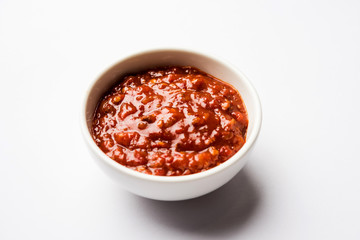Schezwan Sauce / Szechuan chutney is an important ingredient in Chinese recipe. served in a bowl, isolated.  selective focus