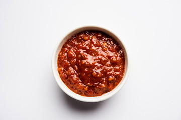 Schezwan Sauce / Szechuan chutney is an important ingredient in Chinese recipe. served in a bowl, isolated.  selective focus