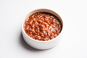 Schezwan Sauce / Szechuan chutney is an important ingredient in Chinese recipe. served in a bowl, isolated.  selective focus