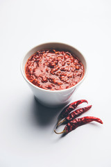 Schezwan Sauce / Szechuan chutney is an important ingredient in Chinese recipe. served in a bowl, isolated.  selective focus