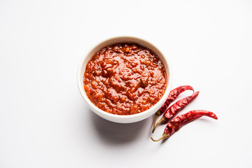 Schezwan Sauce / Szechuan chutney is an important ingredient in Chinese recipe. served in a bowl, isolated.  selective focus