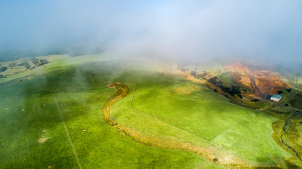 Mist and clouds over green farmland. Auckland, New Zealand