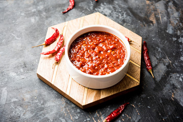 Schezwan Sauce / Szechuan chutney is an important ingredient in Chinese recipe. served in a bowl, isolated.  selective focus