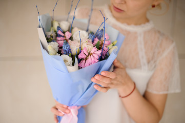 Close shot of girl holding beautiful bouquet with hyacinths