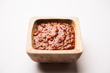 Schezwan Sauce / Szechuan chutney is an important ingredient in Chinese recipe. served in a bowl, isolated.  selective focus