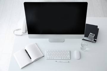 Stylish workplace with modern computer on desk, top view